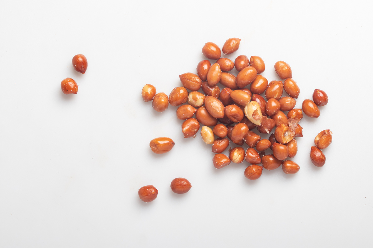 salted fried peanuts on white background